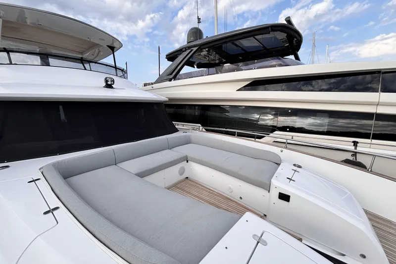 T&b Yacht Photos Pics 2025 Azimut Magellano 66 yacht with spacious deck seating under a cloudy sky.