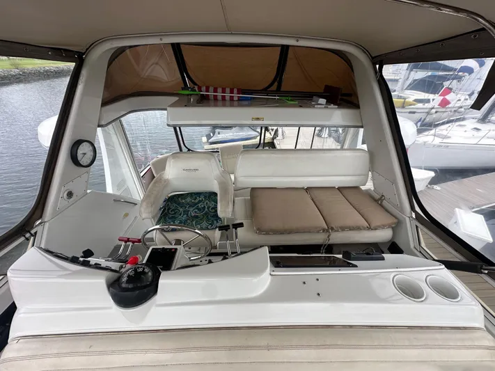 Whiskey Business Yacht Photos Pics 1999 Carver 404 Cockpit Motor Yacht interior with helm and seating area.