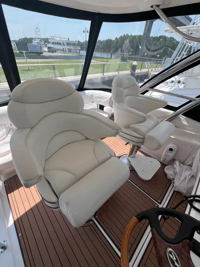 Greatest Escape Yacht Photos Pics Luxurious interior of 2006 Sea Ray 58 Sedan Bridge with plush white seating.