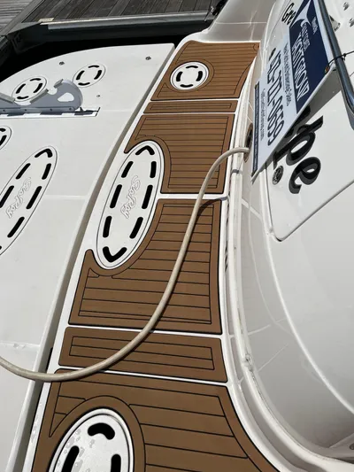 Greatest Escape Yacht Photos Pics 2006 Sea Ray 58 Sedan Bridge yacht deck with wood-style flooring.