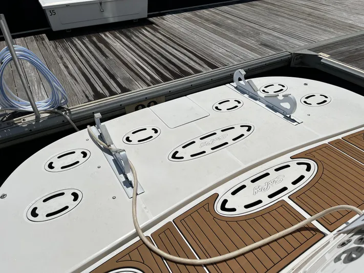 Greatest Escape Yacht Photos Pics 2006 Sea Ray 58 Sedan Bridge swim platform with teak decking and dock view.