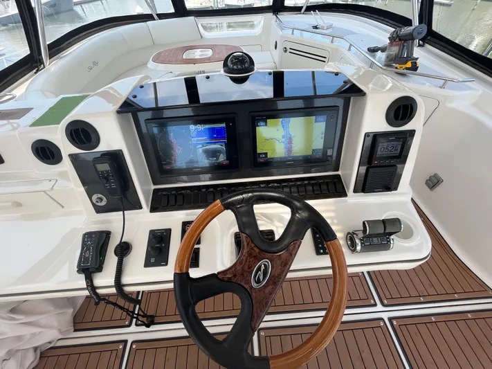 Greatest Escape Yacht Photos Pics 2006 Sea Ray 58 Sedan Bridge helm with dual navigation screens and wood-accented steering wheel.