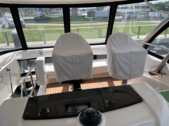 Greatest Escape Yacht Photos Pics 2006 Sea Ray 58 Sedan Bridge helm with covered seats and panoramic windows.