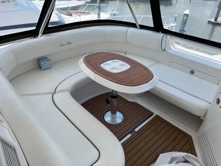 Greatest Escape Yacht Photos Pics Luxurious seating area on 2006 Sea Ray 58 Sedan Bridge yacht with wooden table.