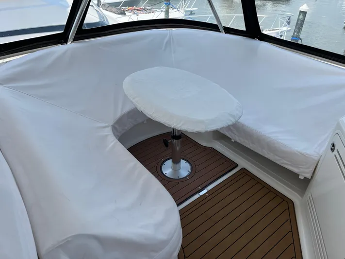 Greatest Escape Yacht Photos Pics 2006 Sea Ray 58 Sedan Bridge interior with covered seating and table.