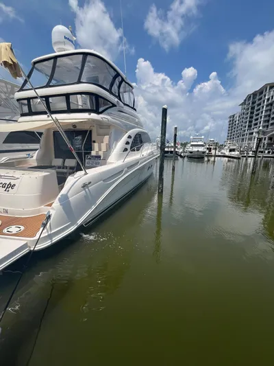 Greatest Escape Yacht Photos Pics 2006 Sea Ray 58 Sedan Bridge yacht docked in marina under blue sky.