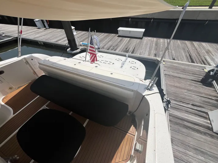 Greatest Escape Yacht Photos Pics 2006 Sea Ray 58 Sedan Bridge yacht docked, featuring spacious deck and American flag.