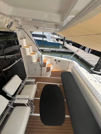 Greatest Escape Yacht Photos Pics 2006 Sea Ray 58 Sedan Bridge yacht interior with seating and wooden flooring.