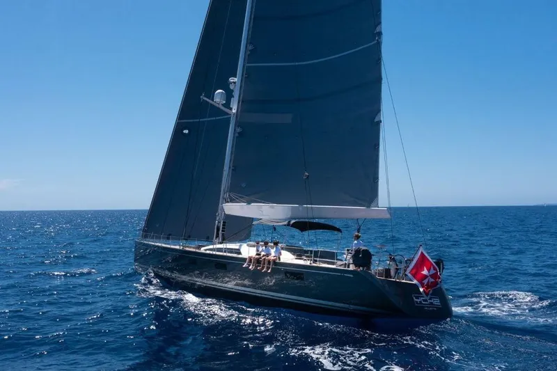 Ych2 Yacht Photos Pics Sailing yacht Nautor Swan 90, 2009 model, cruising on open sea under clear blue sky.