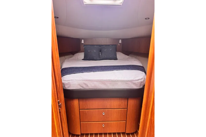  Yacht Photos Pics Luxurious cabin interior of 2014 Tiara Yachts 4300 Open with cozy bedding.