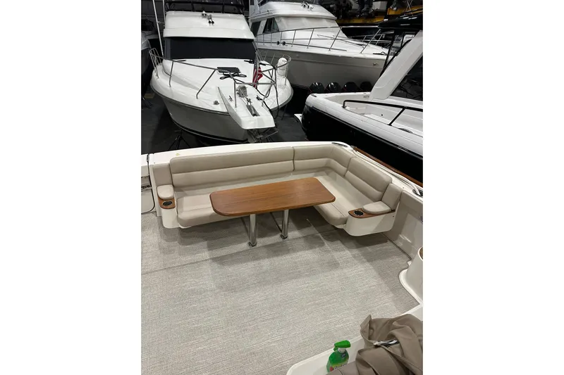  Yacht Photos Pics 2014 Tiara Yachts 4300 Open with spacious seating and wooden table in marina setting.