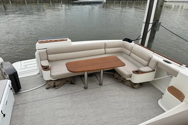  Yacht Photos Pics 2014 Tiara Yachts 4300 Open with elegant seating and wooden table on deck.