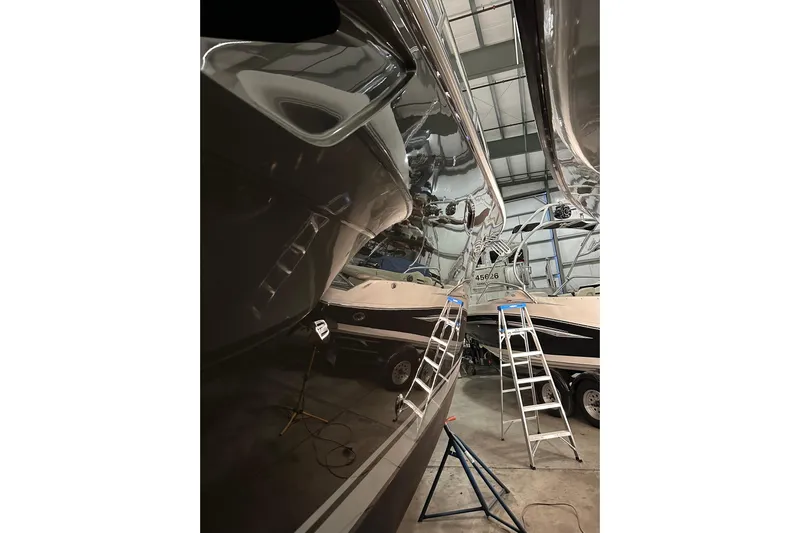  Yacht Photos Pics 2014 Tiara Yachts 4300 Open in a workshop with ladders and polished hull.