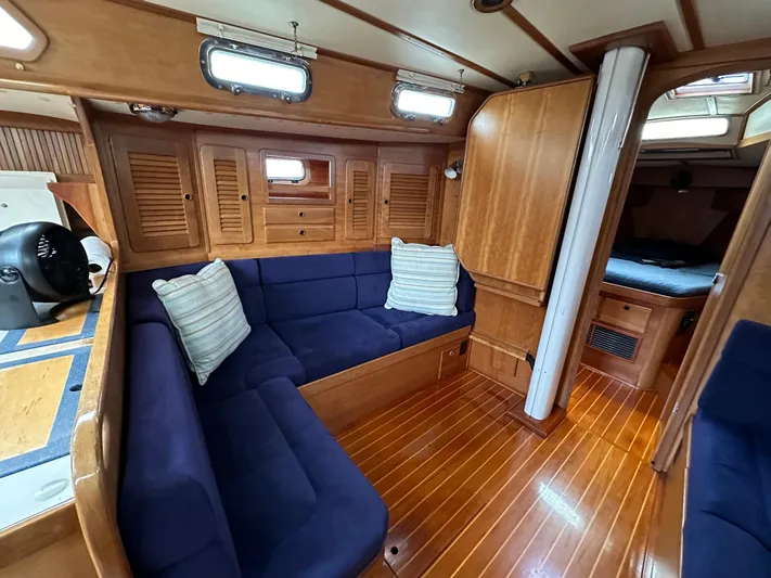 Innisfree Yacht Photos Pics Cozy interior of 1994 Sabre SABRE 425 yacht with blue seating and wooden finishes.