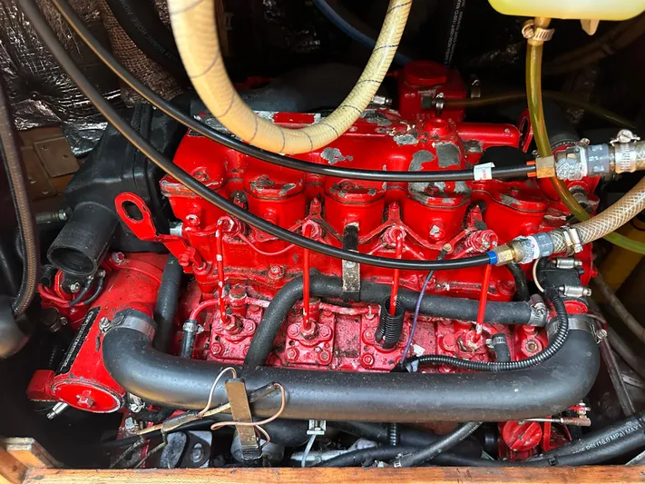 Innisfree Yacht Photos Pics Red engine of a 1994 Sabre SABRE 425 with visible hoses and components.