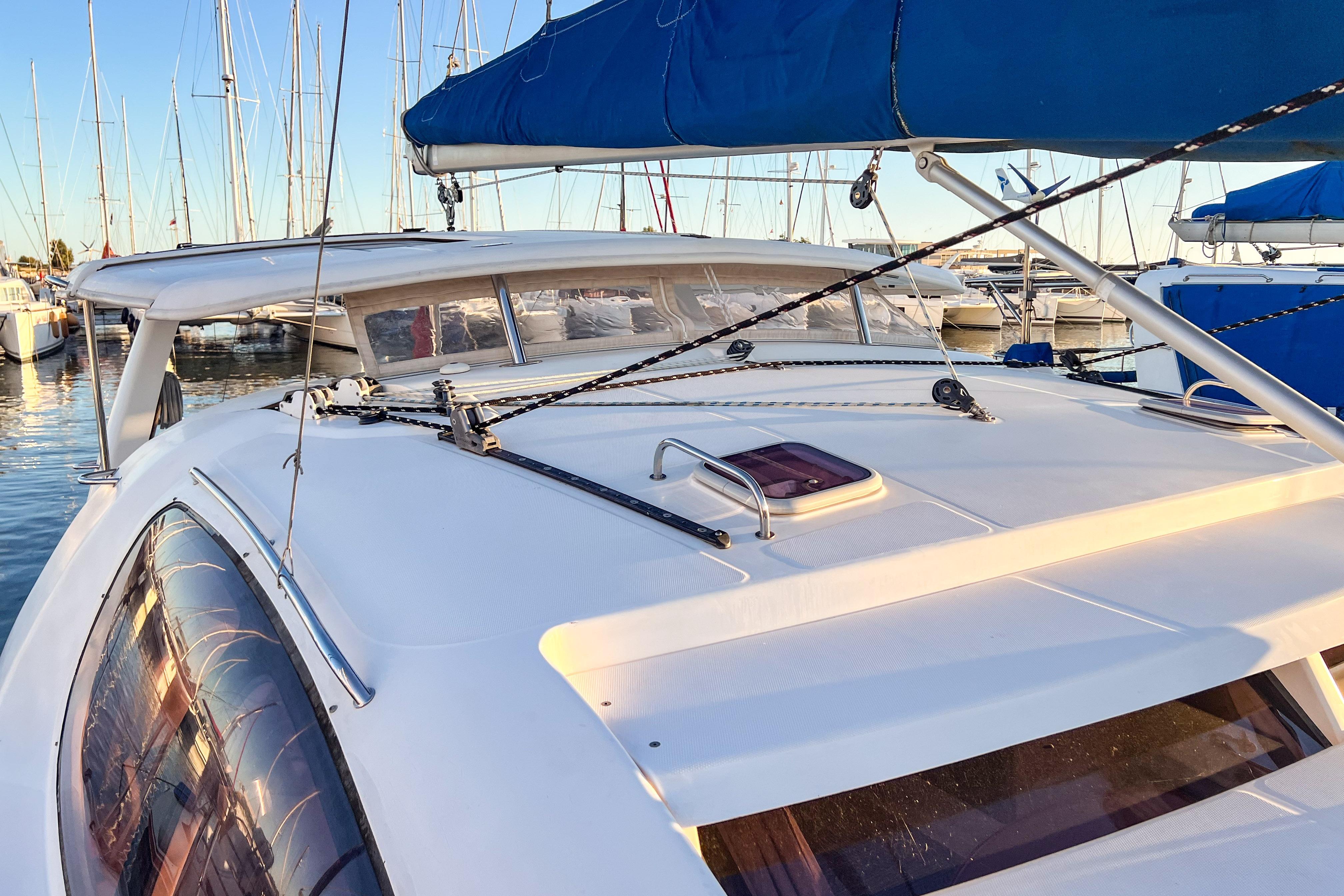 2006 Robertson Leopard 40 catamaran docked in marina, featuring sleek design and blue sail.