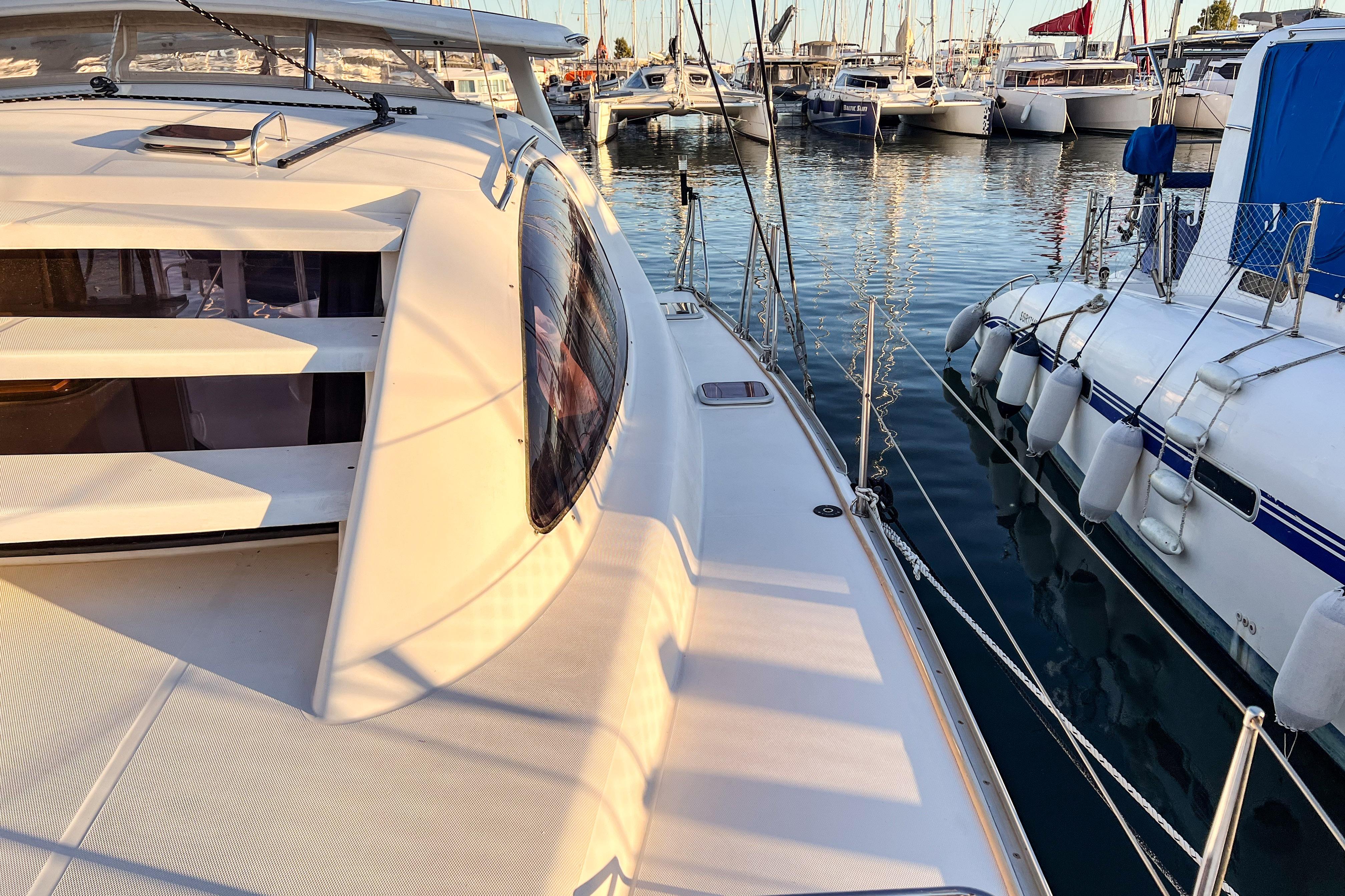 2006 Robertson Leopard 40 catamaran docked in a marina, surrounded by other boats.
