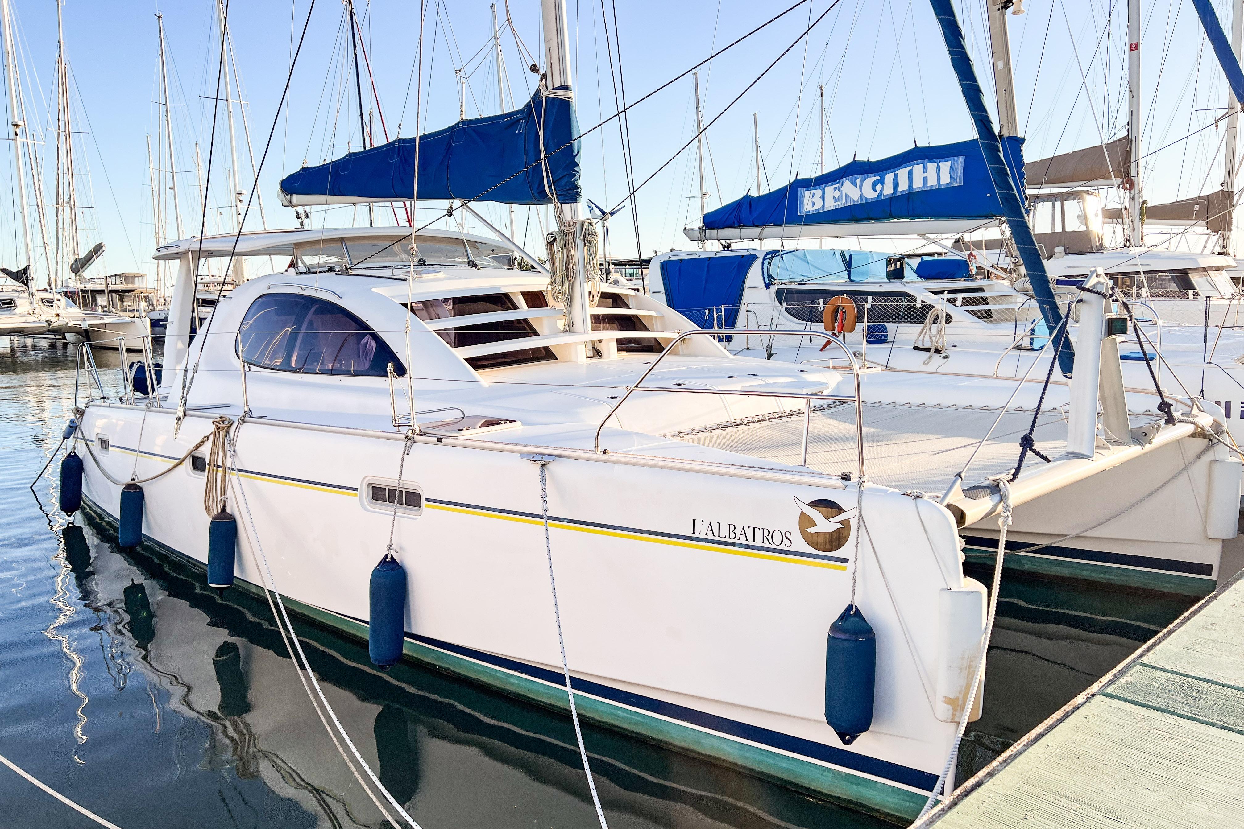 2006 Robertson Leopard 40 catamaran docked at marina, featuring sleek design and blue accents.