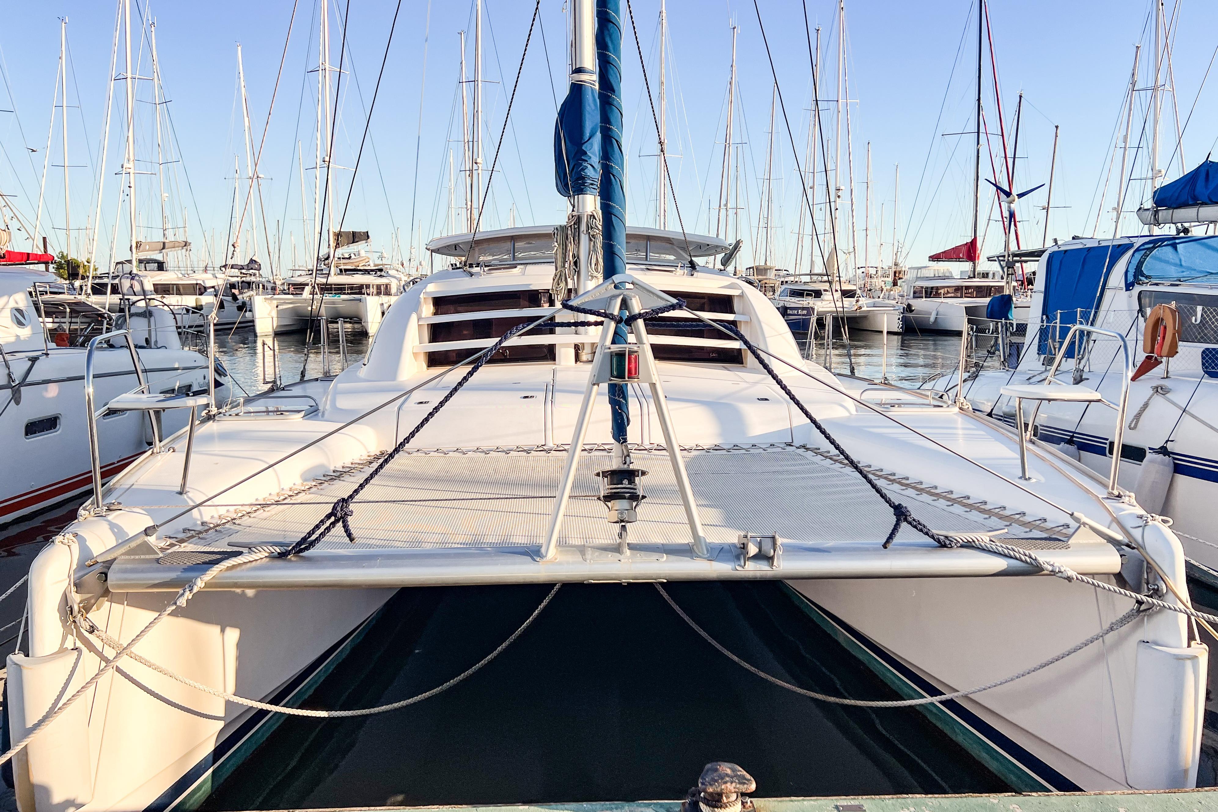 2006 Robertson Leopard 40 catamaran docked in a marina, surrounded by sailboats.