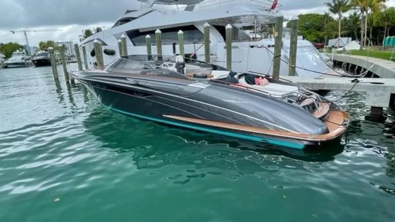 Lady D Yacht Photos Pics 2015 Riva Rivarama Super yacht docked in a marina, sleek design, calm water.