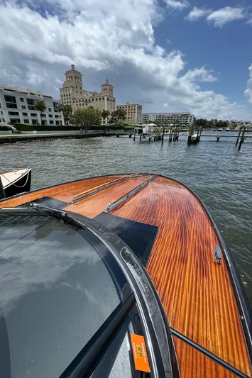 Lady D Yacht Photos Pics 2015 Riva Rivarama Super boat on water near elegant waterfront buildings.