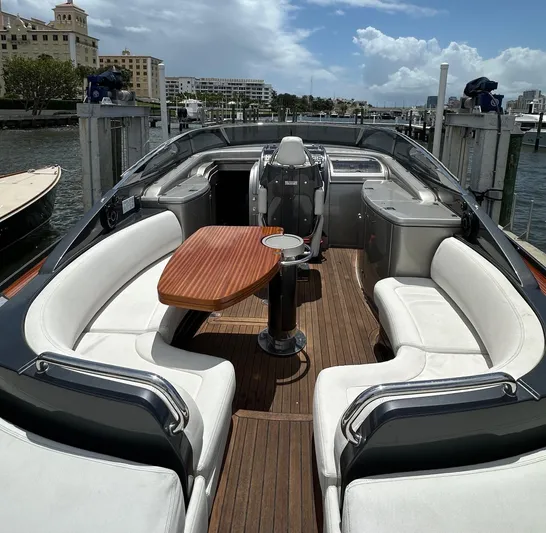 Lady D Yacht Photos Pics 2015 Riva Rivarama Super yacht with elegant seating and wooden deck, docked at marina.