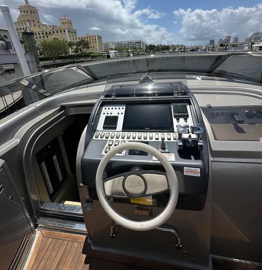Lady D Yacht Photos Pics Cockpit of 2015 Riva Rivarama Super yacht with steering wheel and control panel, docked by waterfront.