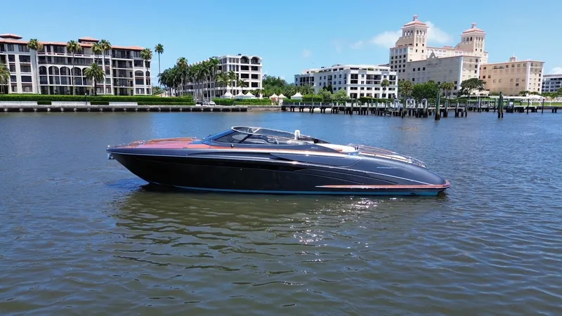 Lady D Yacht Photos Pics 2015 Riva Rivarama Super yacht on calm water with luxury buildings in the background.