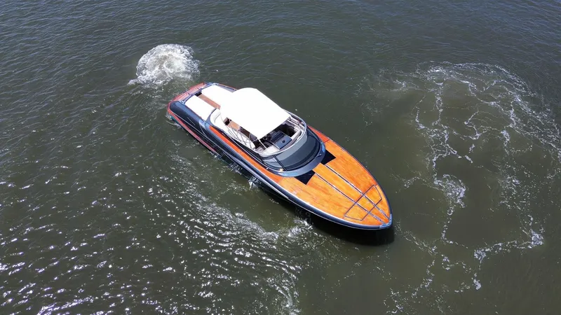 Lady D Yacht Photos Pics 2015 Riva Rivarama Super yacht cruising on open water, aerial view.