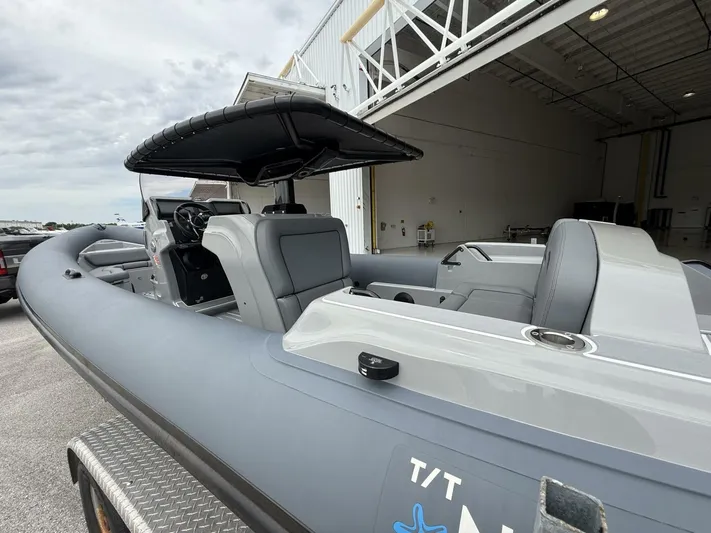  Yacht Photos Pics 2022 Ribeye 8.1m Outboard BL boat with sleek design, docked near a warehouse.