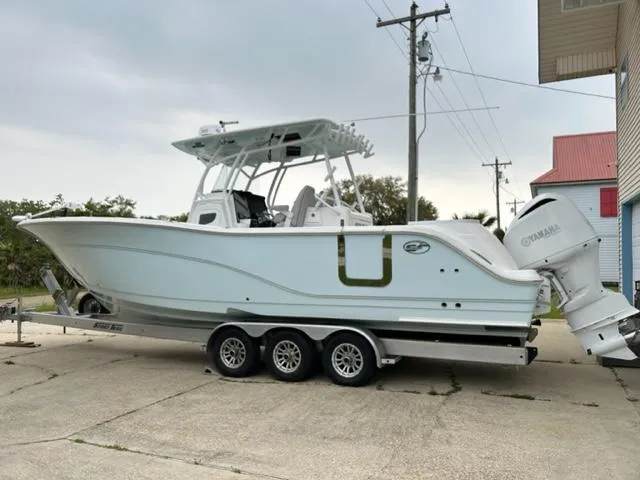 Middle Man Yacht Photos Pics 2019 Sea Fox 328 Commander boat on a trailer, parked outdoors.