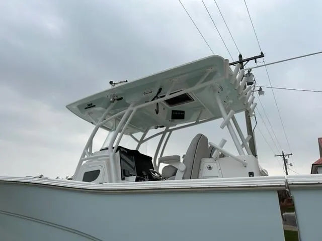Middle Man Yacht Photos Pics 2019 Sea Fox 328 Commander boat with T-top and electronics, under cloudy sky.