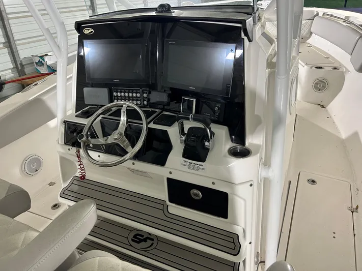 Middle Man Yacht Photos Pics 2019 Sea Fox 328 Commander boat cockpit with dual screens and steering wheel.