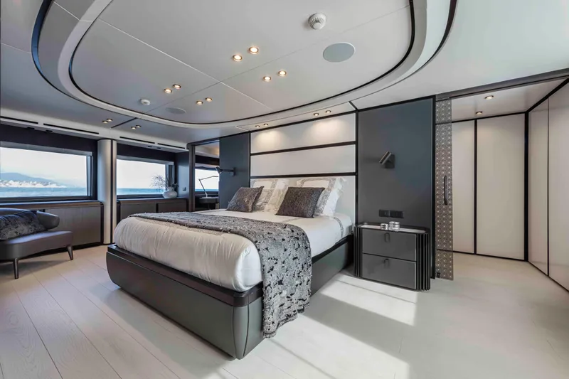 X130 Triplex Yacht Photos Pics Luxurious bedroom on the 2026 Extra X130 TRIPLEX yacht with modern design and ocean view.