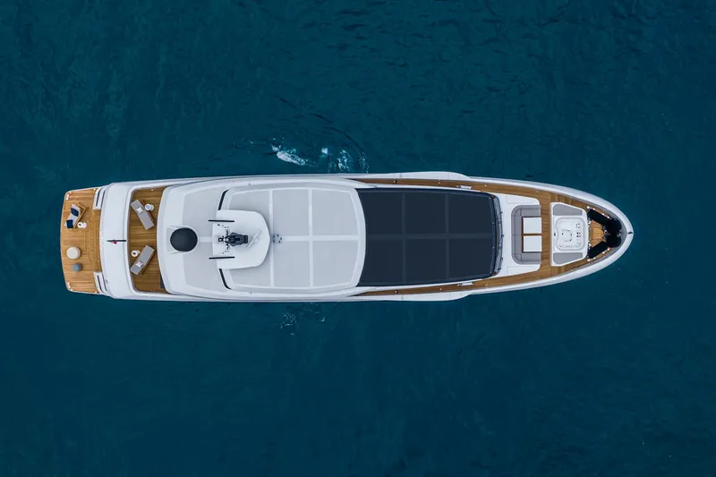 X130 Triplex Yacht Photos Pics Aerial view of 2026 Extra X130 TRIPLEX yacht cruising on blue water.