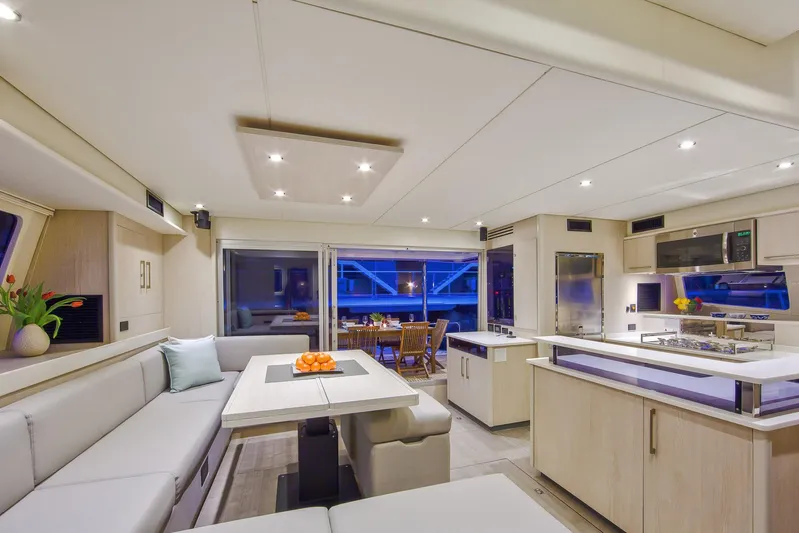 Between Yacht Photos Pics Luxurious interior of 2018 Leopard 58 yacht with modern kitchen and dining area.