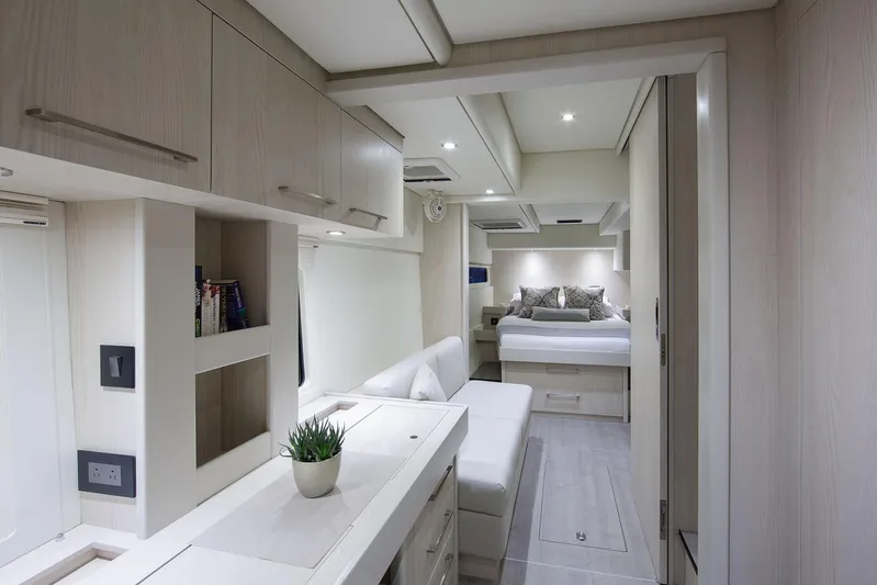 Between Yacht Photos Pics Luxurious interior of 2018 Leopard 58 yacht with modern furnishings and cozy bedroom.