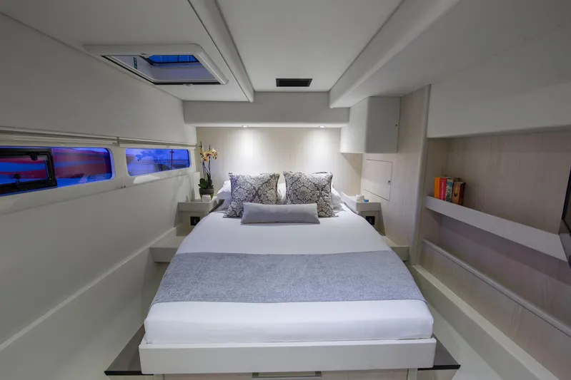 Between Yacht Photos Pics Luxurious bedroom interior of 2018 Leopard 58 yacht with modern design and cozy bedding.