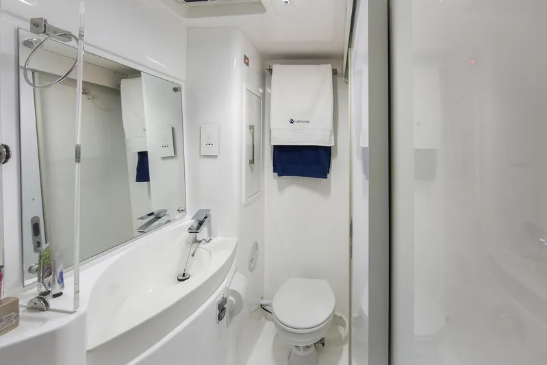 Between Yacht Photos Pics Modern bathroom in a 2018 Leopard 58 yacht, featuring sleek fixtures and elegant design.