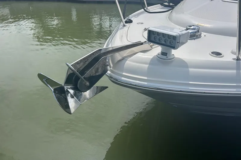 Whataboat Yacht Photos Pics Bow of 2005 Sea Ray 360 Sundancer with anchor and spotlight, docked on calm water.