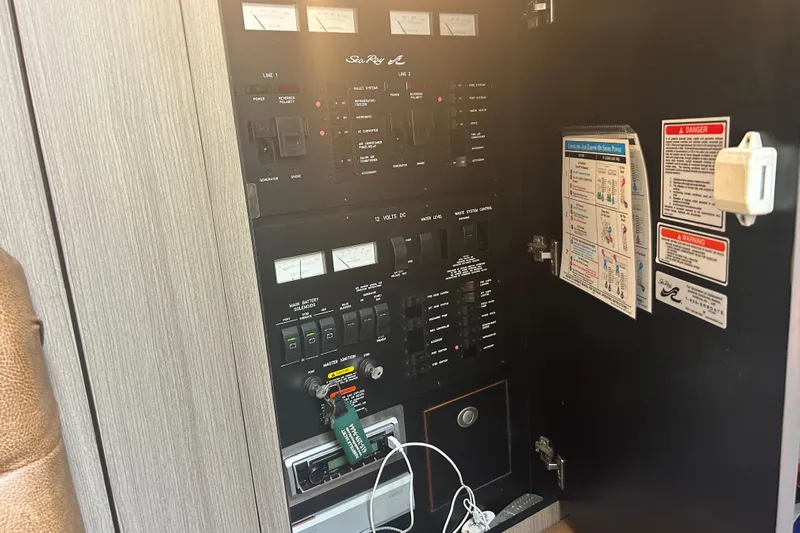 Whataboat Yacht Photos Pics Electrical control panel of a 2005 Sea Ray 360 Sundancer boat, featuring switches and gauges.