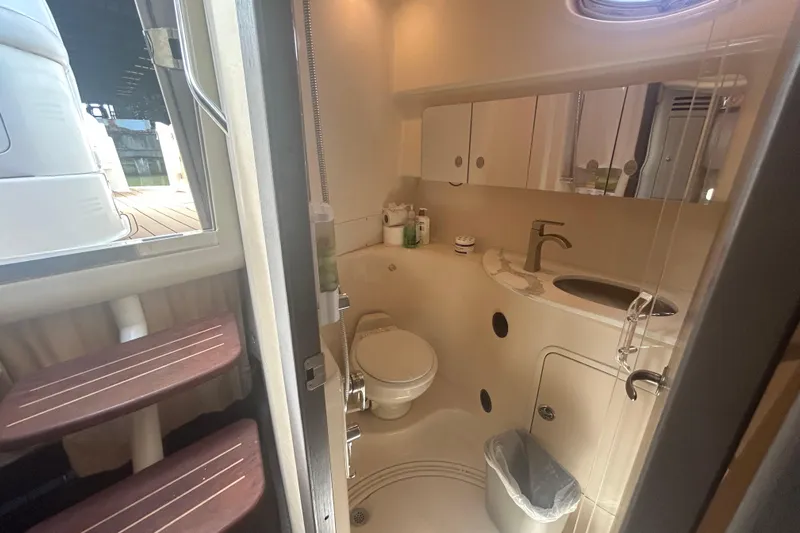 Whataboat Yacht Photos Pics Bathroom interior of 2005 Sea Ray 360 Sundancer yacht, featuring sink and toilet.