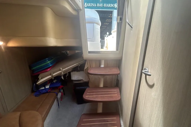 Whataboat Yacht Photos Pics Interior of 2005 Sea Ray 360 Sundancer with wooden steps and storage area.