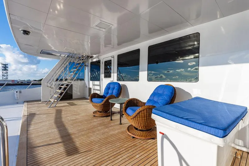 Empire Sea Yacht Photos Pics Deck of a 2009 Custom Crystal Yacht with blue chairs.