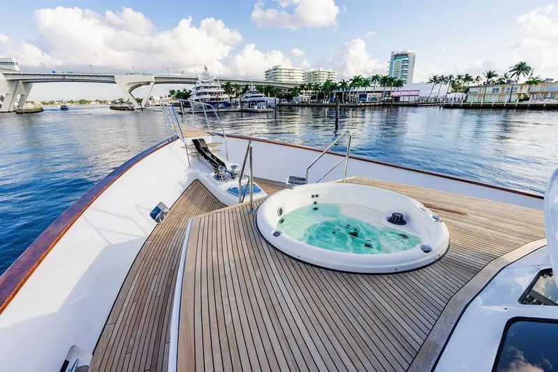 Empire Sea Yacht Photos Pics Luxury yacht with deck jacuzzi, harbor in background.