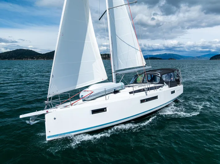 Into The Blue Yacht Photos Pics 2022 Jeanneau Sun Odyssey 410 sailing on open water under clear skies.