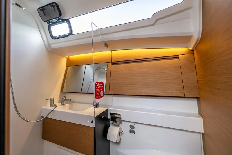 Into The Blue Yacht Photos Pics Modern bathroom interior of 2022 Jeanneau Sun Odyssey 410 yacht with sleek design.