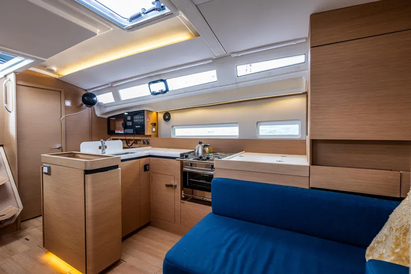 Into The Blue Yacht Photos Pics Modern interior of 2022 Jeanneau Sun Odyssey 410 yacht with sleek kitchen design.