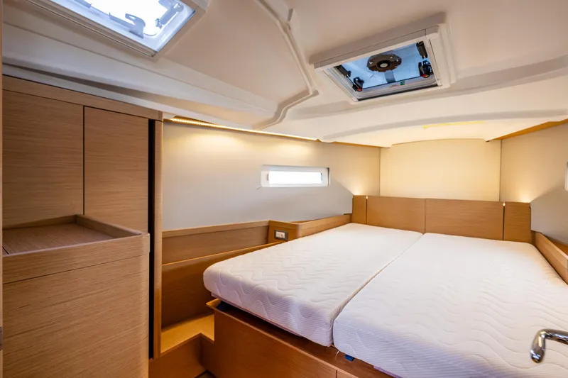 Into The Blue Yacht Photos Pics Interior cabin of 2022 Jeanneau Sun Odyssey 410 yacht, featuring a spacious bed and modern design.