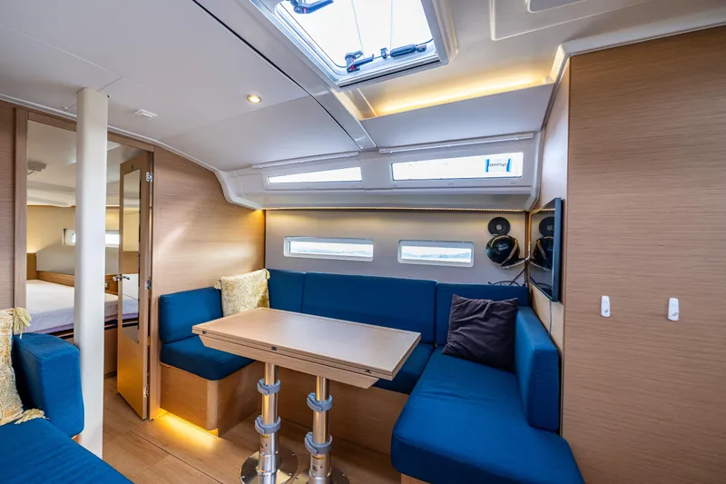Into The Blue Yacht Photos Pics Interior of 2022 Jeanneau Sun Odyssey 410 yacht with modern seating and dining area.